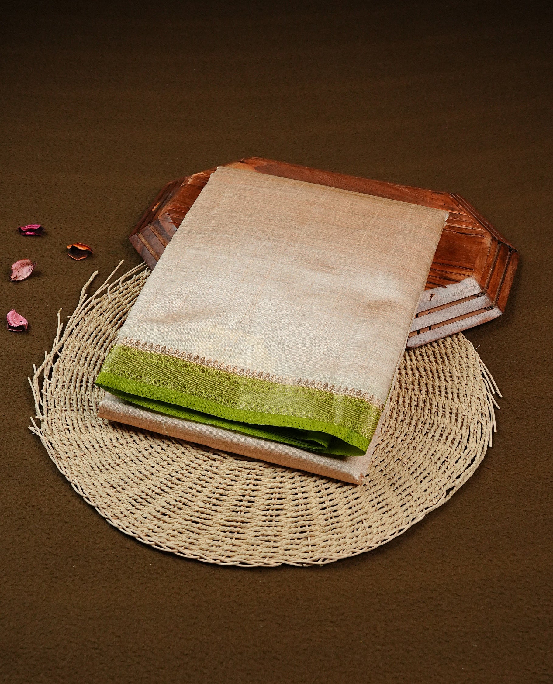 Light gold Colour Tussar saree featuring elegant plain body, complemented by contrast Light green colour with zari work border, comes with matching blouse piece.