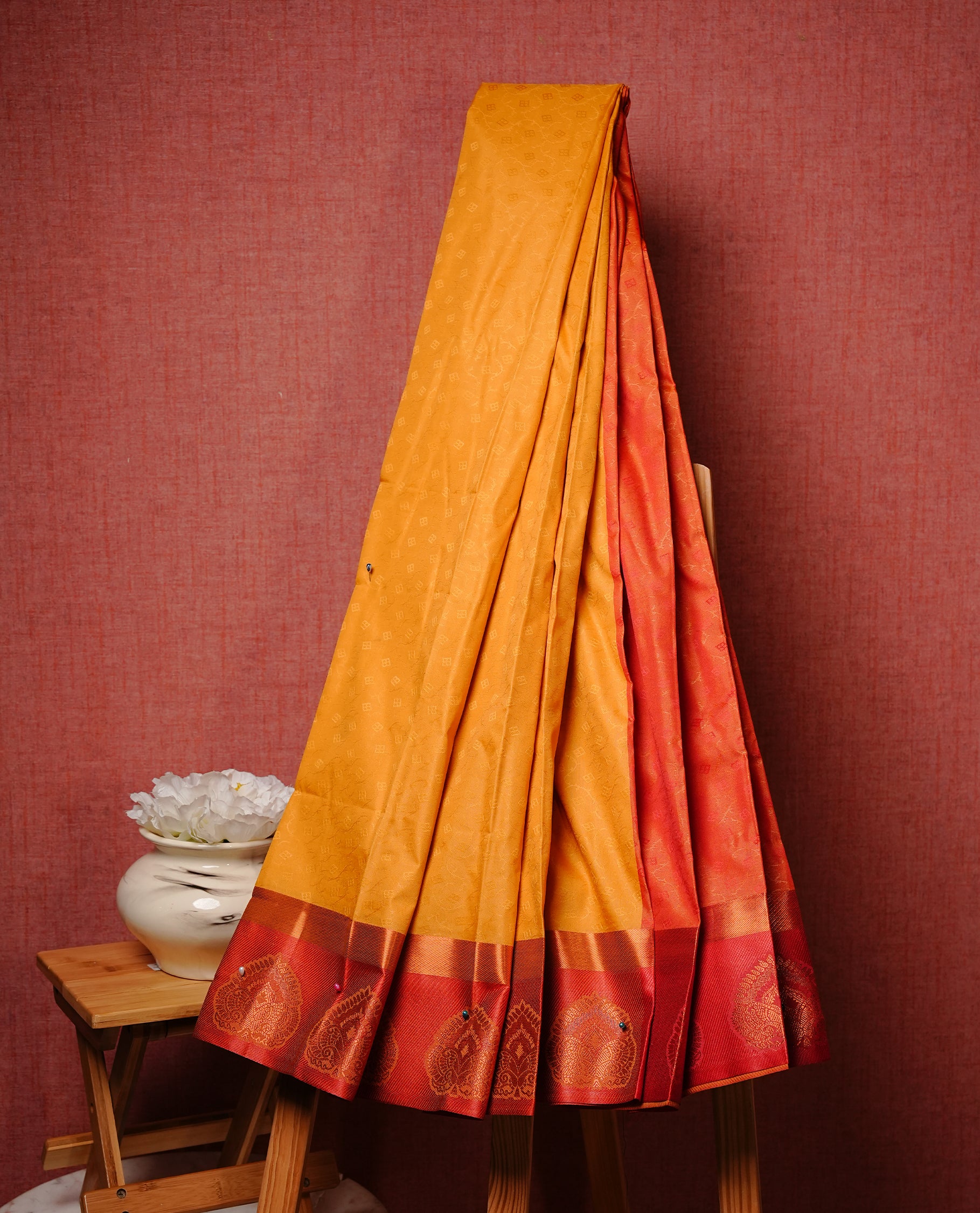 Mustard colour Semi silk saree Featuring self colour zari motifs on body, complemented by contrast Orange colour with gold zari border, paired with matching blouse piece.
