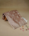 Muted Beige gold colour Mulberry silk saree featuring light gold small buttas & big motifs onbody, complemented by self colour with Light gold zari floral Border, comes with matching blouse piece.