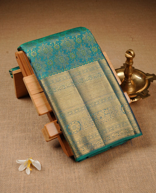 Green & Blue Dual Colour Pure Kancheepuram Silk Saree Featuring Gold Zari Floral  Pattern  on the Body, Highlighting a Traditional Gold Zari Border, Paired with a Matching Blouse Piece.