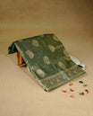 Green colour Mulberry silk saree featuring Gold zari small buttas & floral motifs  on body, complemented by self colour with Gold zari border, comes with matching blouse piece.