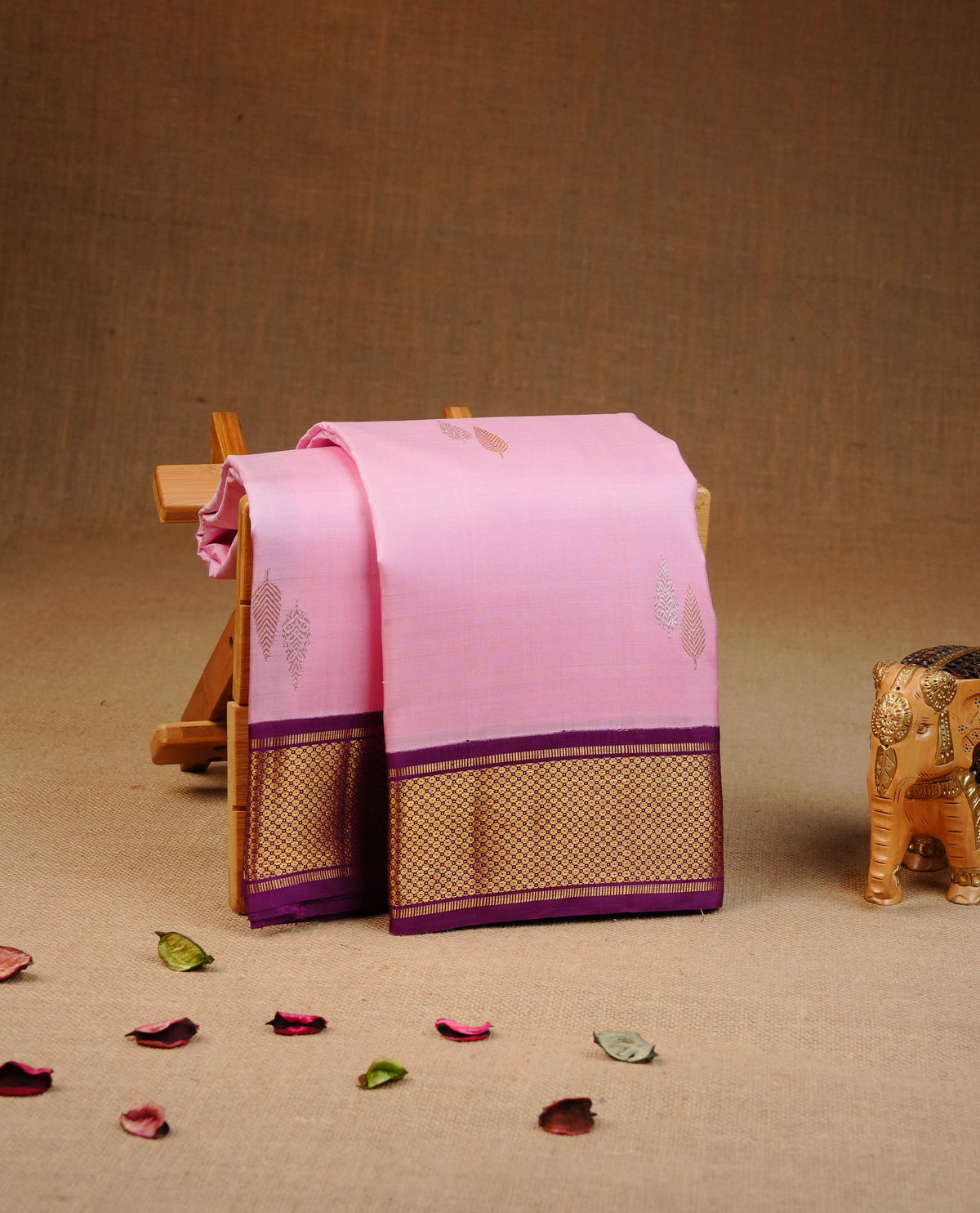 Pink colour Traditional Kancheepuram silk saree featuring Gold & silver zari leaf pattern on body, Contrast purple colour with gold zari border, comes with matching blouse piece.