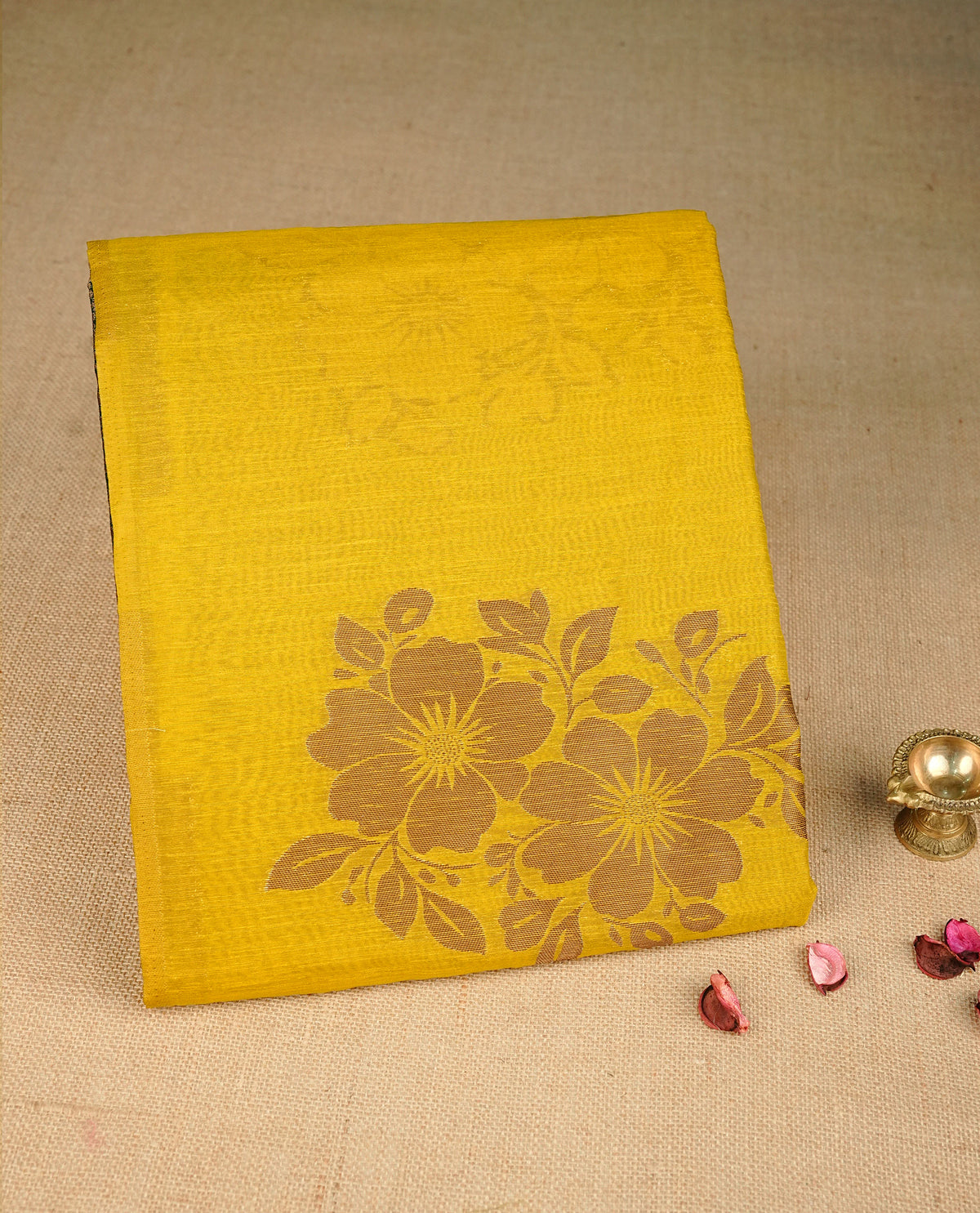 Mustard yellow colour semi linen saree with elegant gold zari floral motifs across the body, complemented by a contrast forest Green colour with grand gold zari pallu and a borderless design, paired with a matching blouse piece.