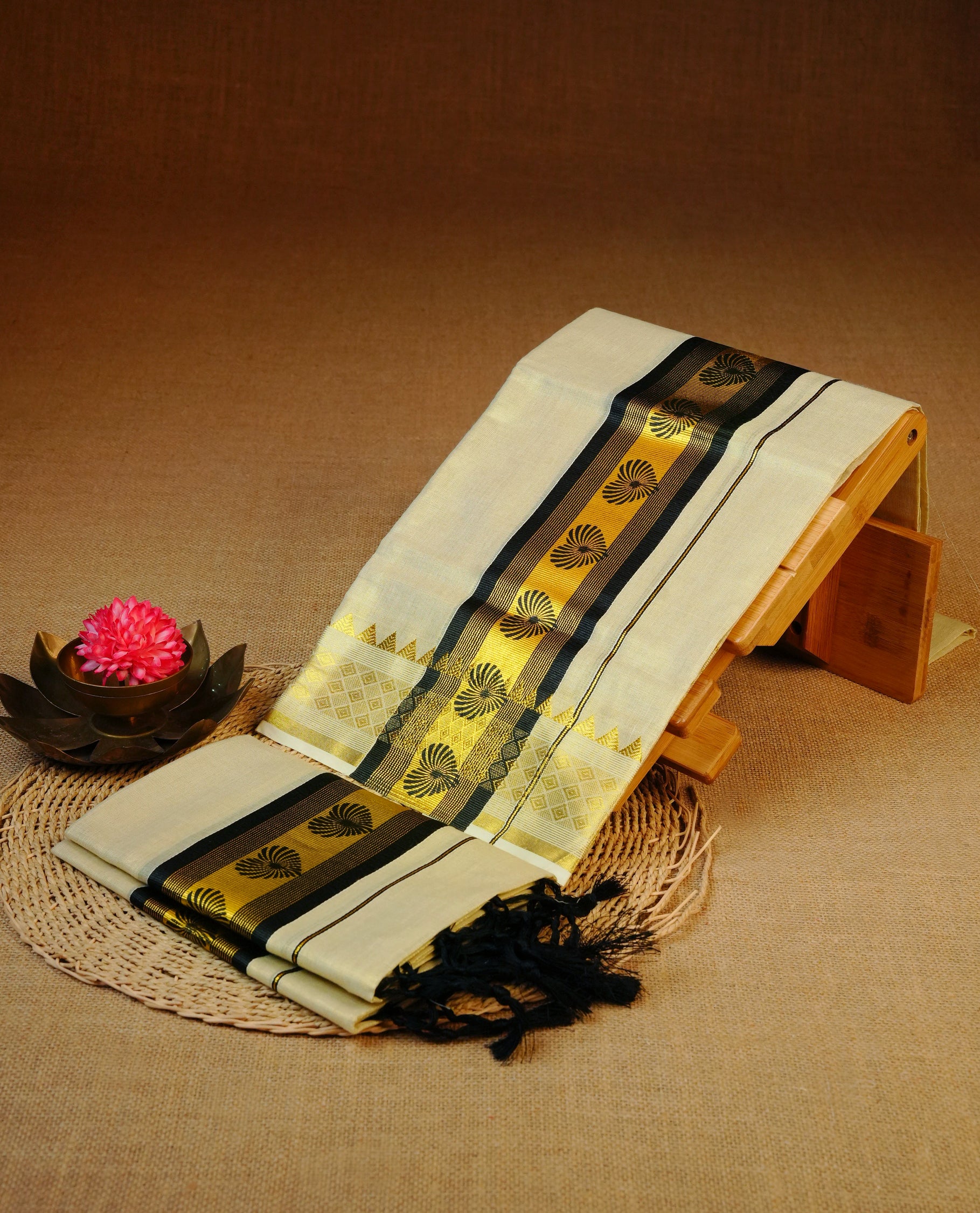 Light gold Tissue Set mundu featuring black heart print on gold kasav kara.