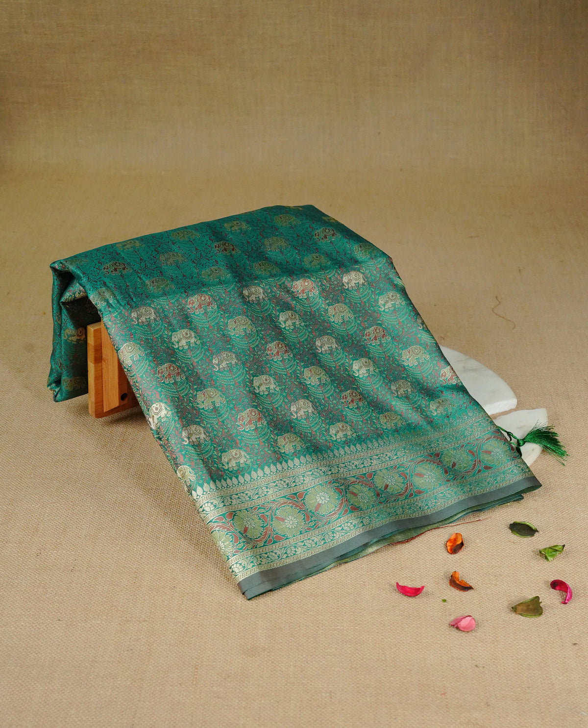 Green colour Mulberry silk saree featuring gold zari elephant & floral kodi pattern across body, complemented by self colour border with gold zari work, comes with matching blouse piece.