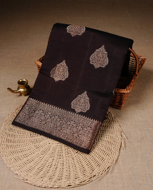 Chocolate Brown Colour Pure Banaras Soft Silk saree featuring Antique Zari buttas in body, complemented by zari work on self colour border, paired with matching Blouse Piece.