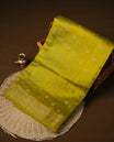 Olive colour pure tussar Banarasi saree featuring Gold zari motifs on body, self colour gold zari border, and a matching blouse piece.