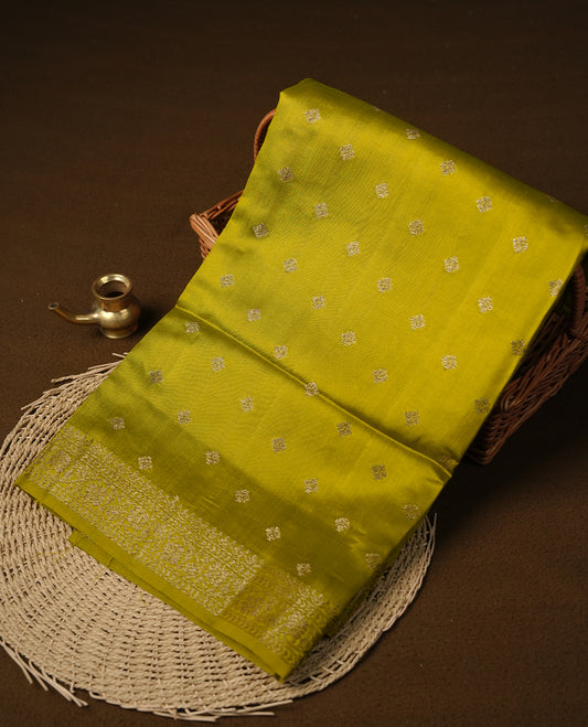 Olive colour pure tussar Banarasi saree featuring Gold zari motifs on body, self colour gold zari border, and a matching blouse piece.