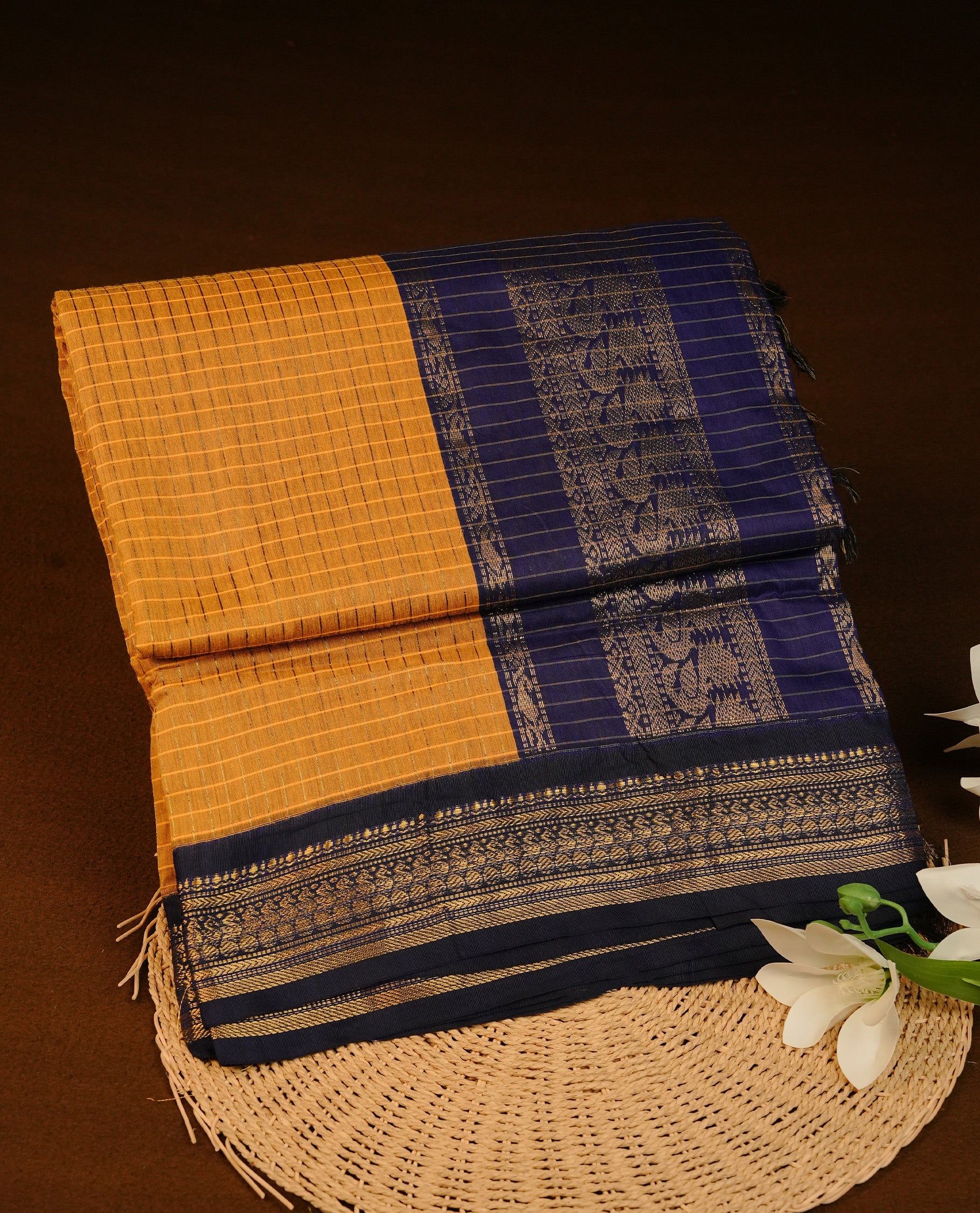 Yellow colour Kalyani cotton saree featuring Gold zari check pattern on body, complemented by Contrast Blue colour with grand gold zari border & pallu, matching blouse piece