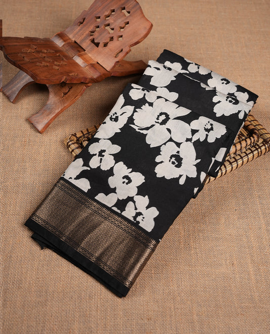 Black colour Viscos semi printed saree featuring a light golden zari border, abstract off white printed motifs on the body, and comes with a matching blouse
