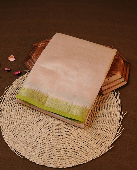 Cream colour Tussar silk saree Featuring Elegant Plain body, complemented by Contrast Light green colour with gold zari border, paired with matching blouse piece.