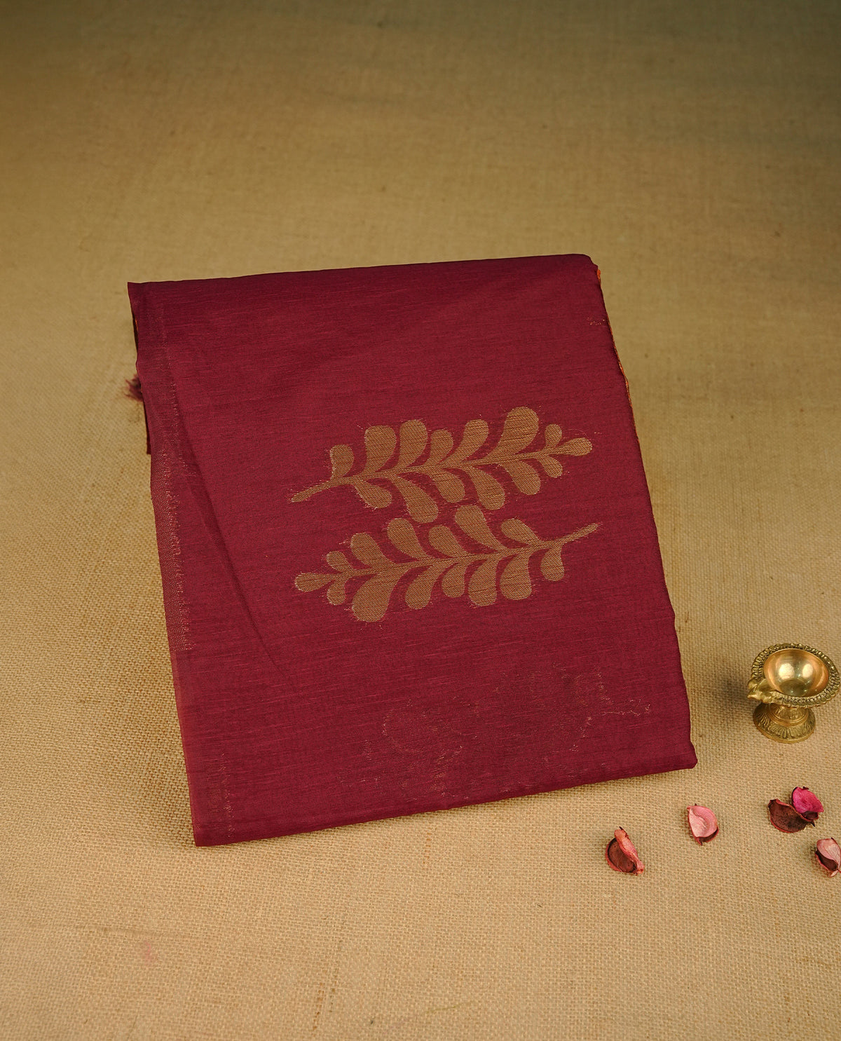Red colour semi silk saree featuring Gold zari Leaf pattern on body, complemented by contrast colour with Gold zari border, comes with matching blouse piece.