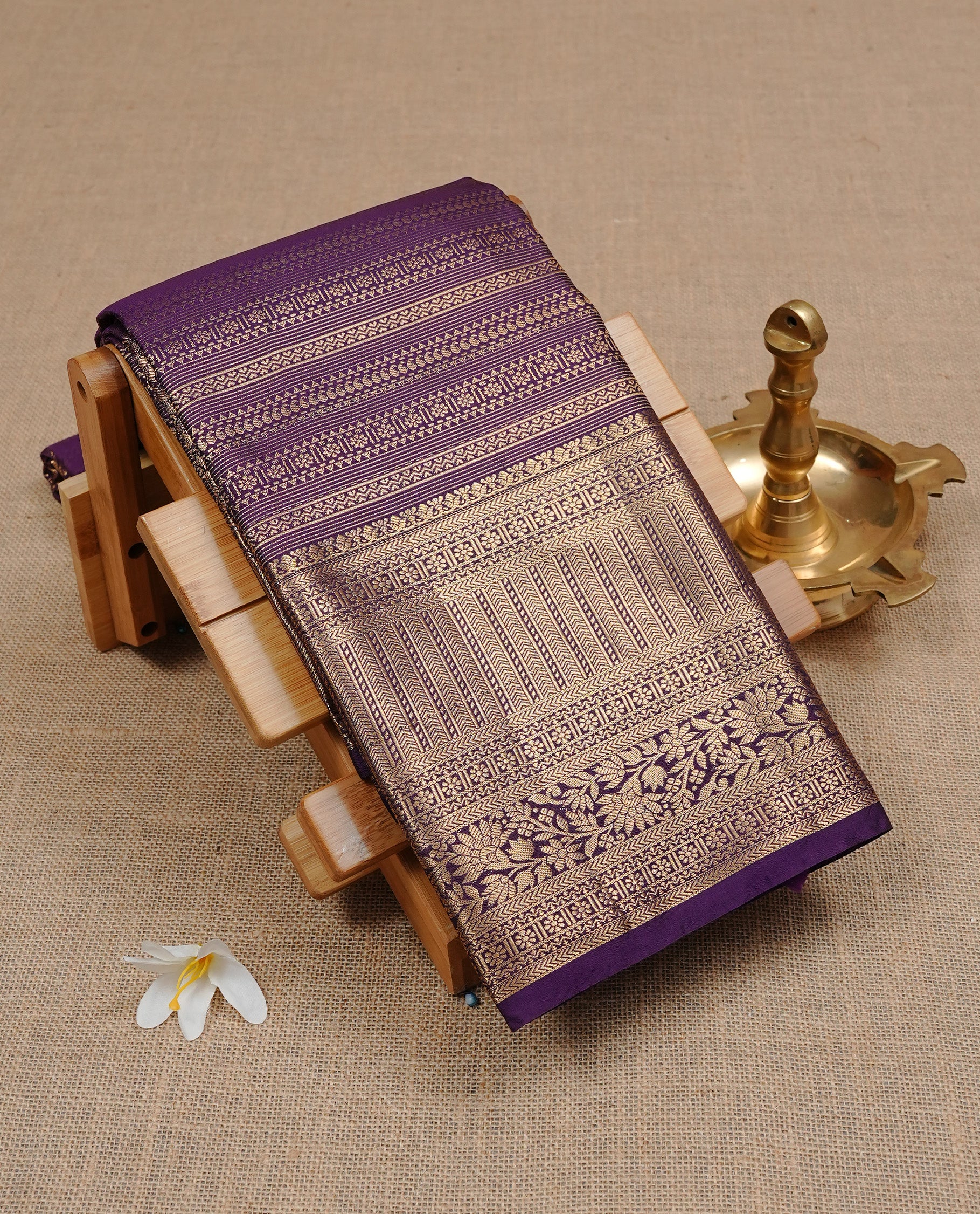Purple Colour Wedding Silk Saree Featuring Gold zari Designed stripes on body, complemented by traditional Zari pattern on self colour border, paired with matching blouse piece.