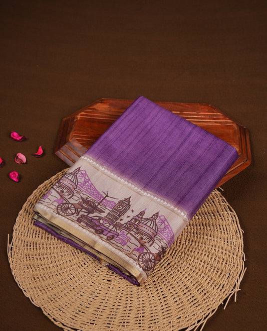 Purple colour semi tusser silk saree featuring contrast cream colour London bridge printed pattern border and paired with matching blouse.