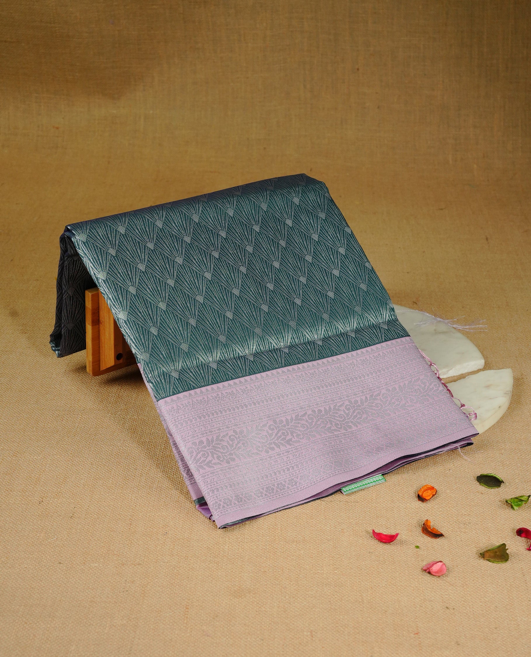 Green colour semi silk saree featuring Silver zari Design pattern on body, complemented by contrast Pink colour with silver zari border, comes with matching blouse piece