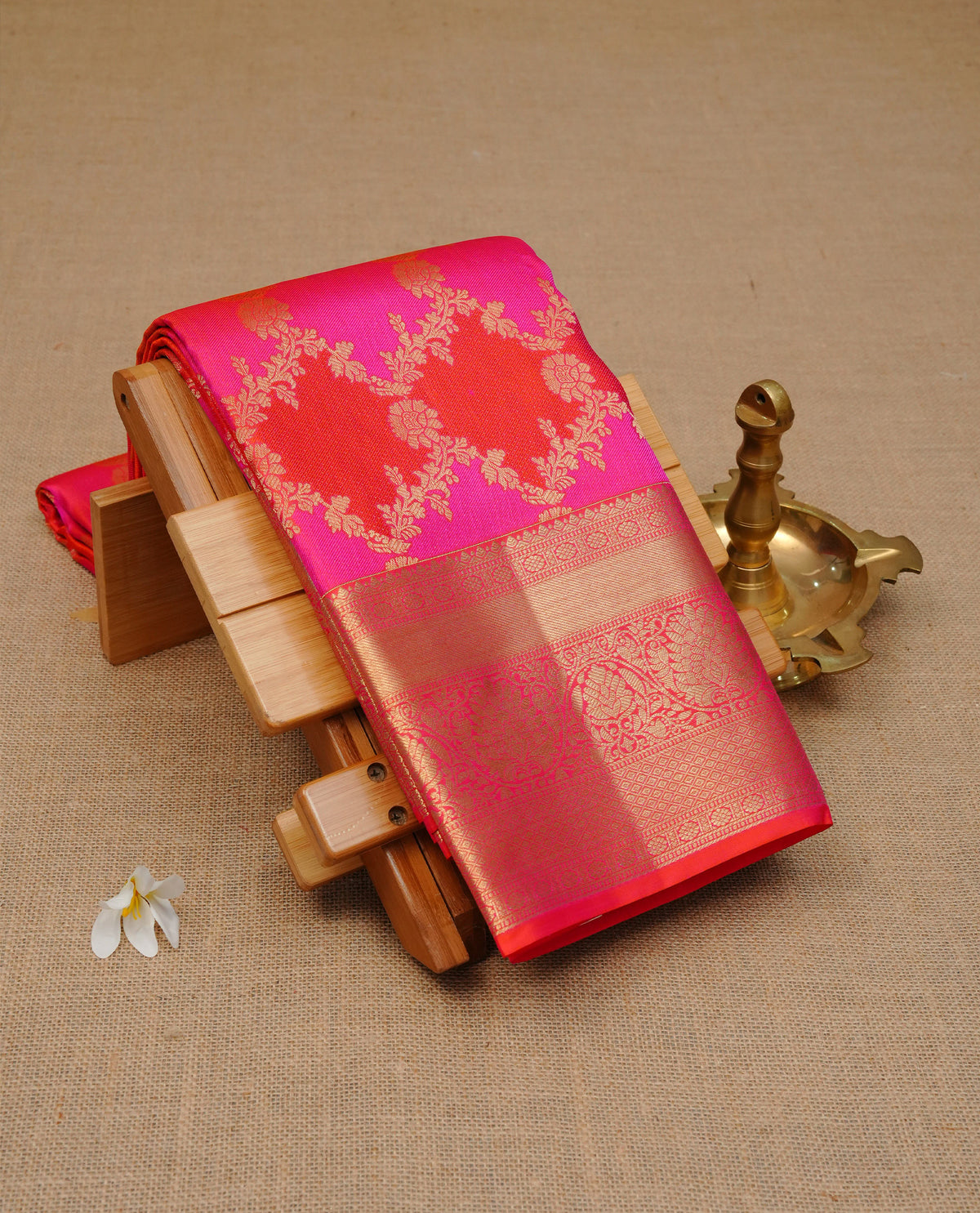 Orange & magenta colour Wedding silk saree featuring gold zari Floral kodi pattern worked body, complemented by Self colour with Traditional border, comes with matching blouse piece.