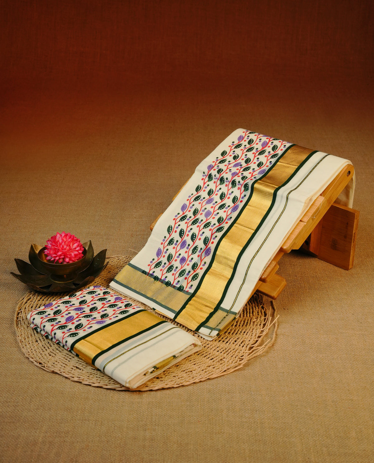 Cream colour cotton set mundu featuring gold kasav with green kara & leaf kodi print..