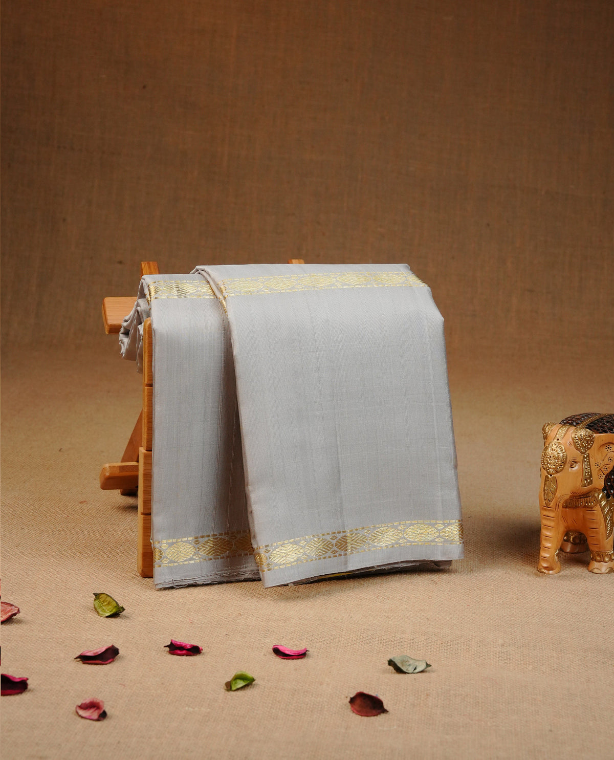 Grey colour Traditional kancheepuram silk saree featuring Motifs on body, complemented by self colour with zari border, comes with matching blouse piece.