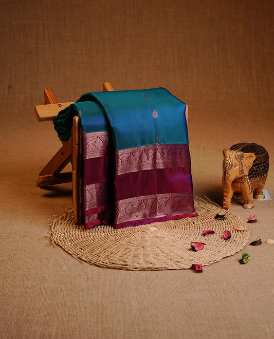 Green & Blue Dual Colour Traditional Kancheepuram Slik Saree Featuring Gold Zari Motifs on the Body, Complemented by a Contrast Purple Colour  Gold Zari Traditional Border and Pallu, Paired with a Matching Blouse .