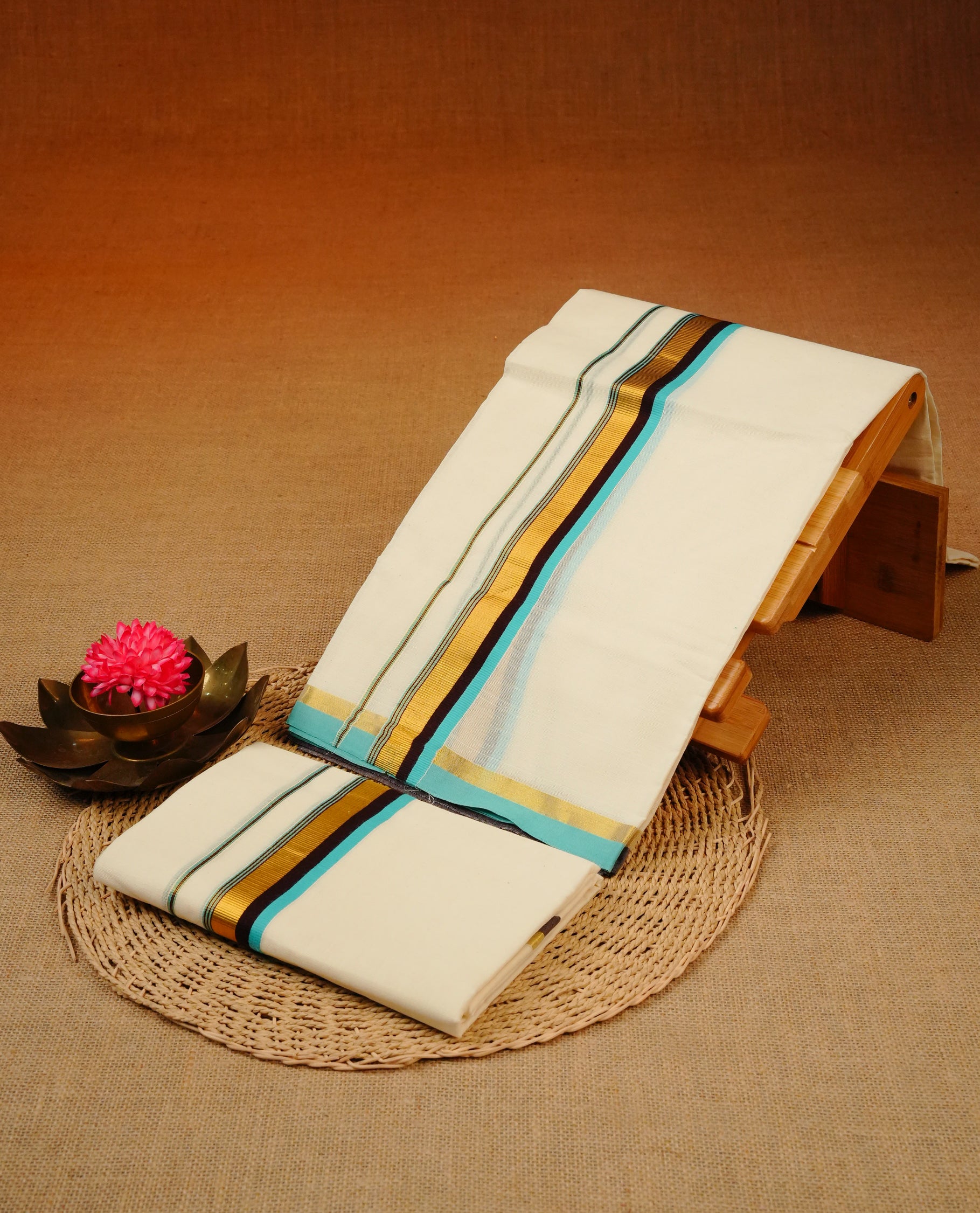 Cream colour Cotton set mundu With plain body, enhance gold zari with Blue & Chocolate colour kara.