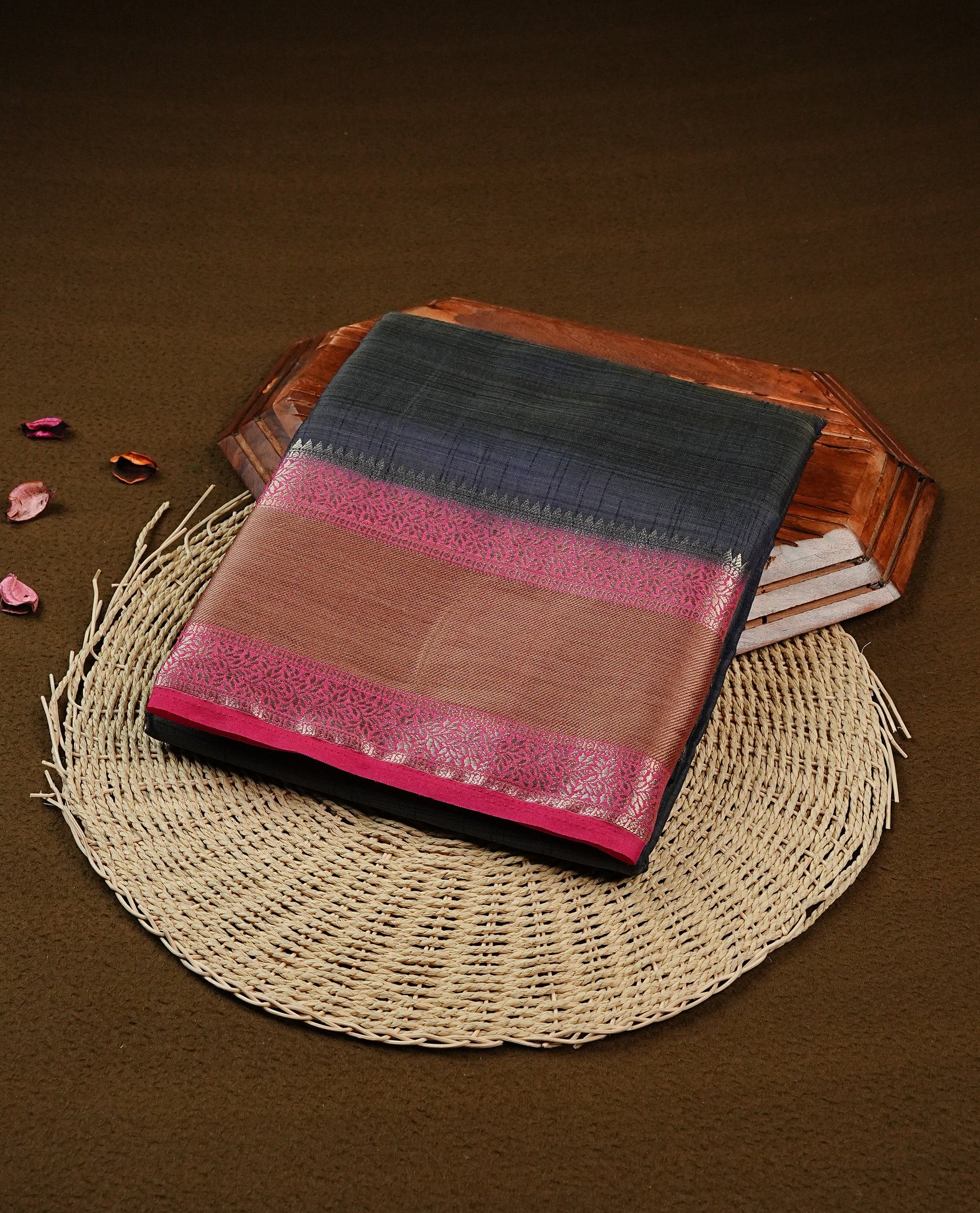Greyish blue colour Tussar saree featuring Gold zari buttas on body, complemented by contrast Magenta & olive Colour with Gold zari border, comes with matching blouse piece.