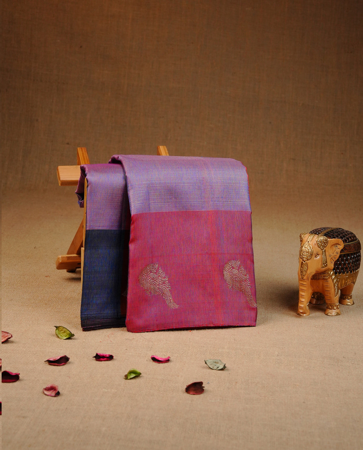 Red & Purple colour traditional kancheepuram silk saree featuring Plain body, complemented by contrast Red colour with gold zari peacock motifs on border, comes with matching blouse piece.