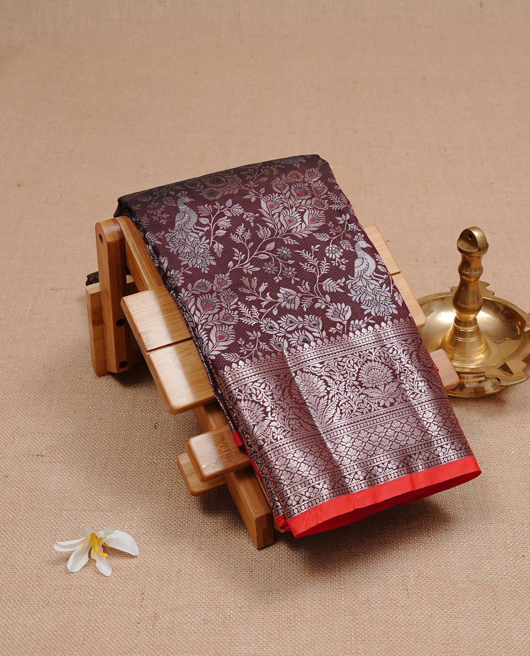 Dark chocolate colour semi wedding silk saree featuring Rose Gold zari Floral kodi pattern with Silver zari peacock motifs on body, complemented Rose gold zari border, paired with matching blouse piece.