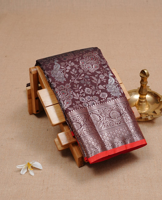 Dark chocolate colour semi wedding silk saree featuring Rose Gold zari Floral kodi pattern with Silver zari peacock motifs on body, complemented Rose gold zari border, paired with matching blouse piece.