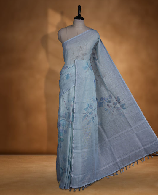 Ice blue colour pure linen saree featuring leaf print pattern across body, silver thin border finished with matching blouse.