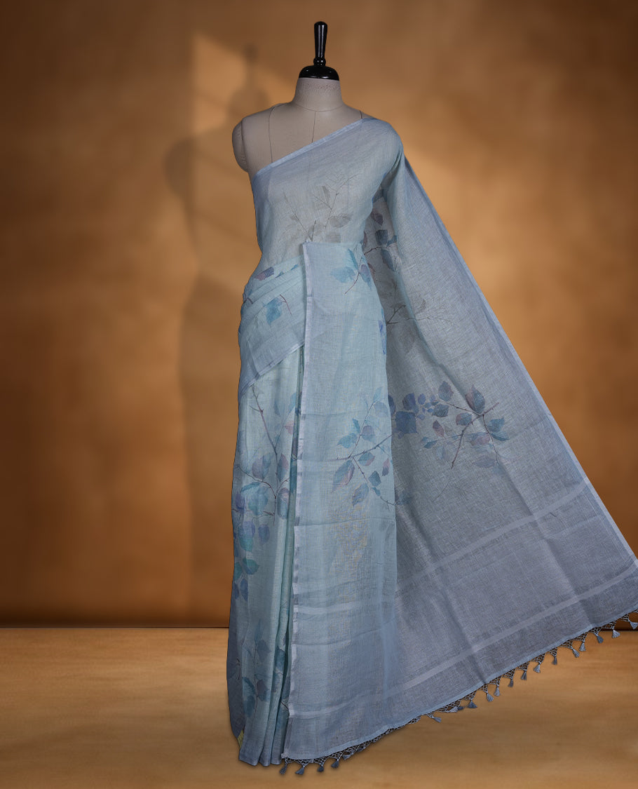 Ice blue colour pure linen saree featuring leaf print pattern across body, silver thin border finished with matching blouse.