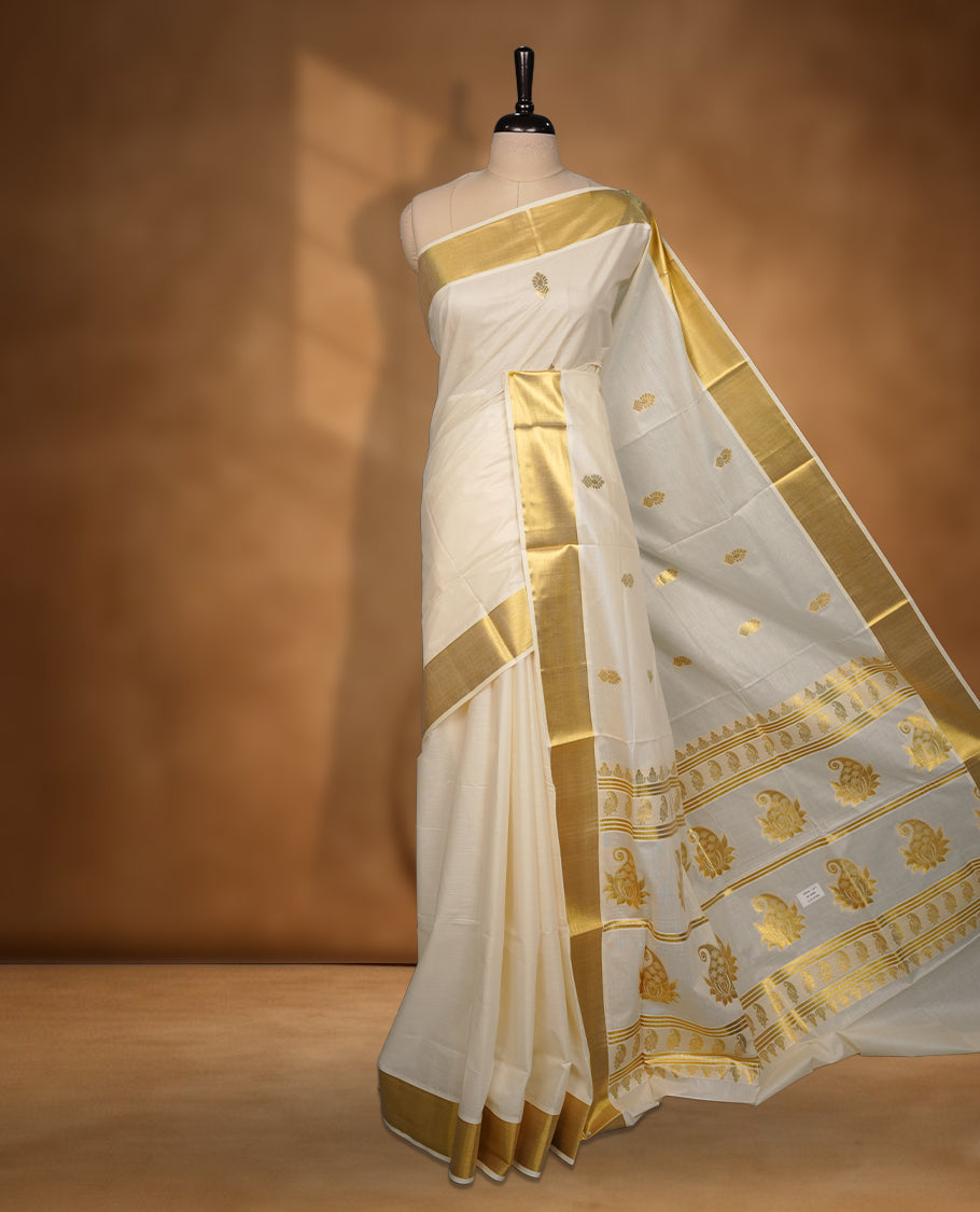 Elegant off white colour cotton Kerala saree with gold zari buttas, broad kasavu border, and richly woven traditional pallu, paired with a matching blouse