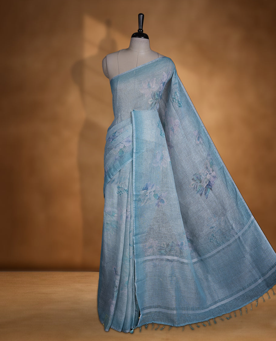Light blue colour pure linen saree featuring Floral print pattern across body, silver thin border finished with matching blouse.