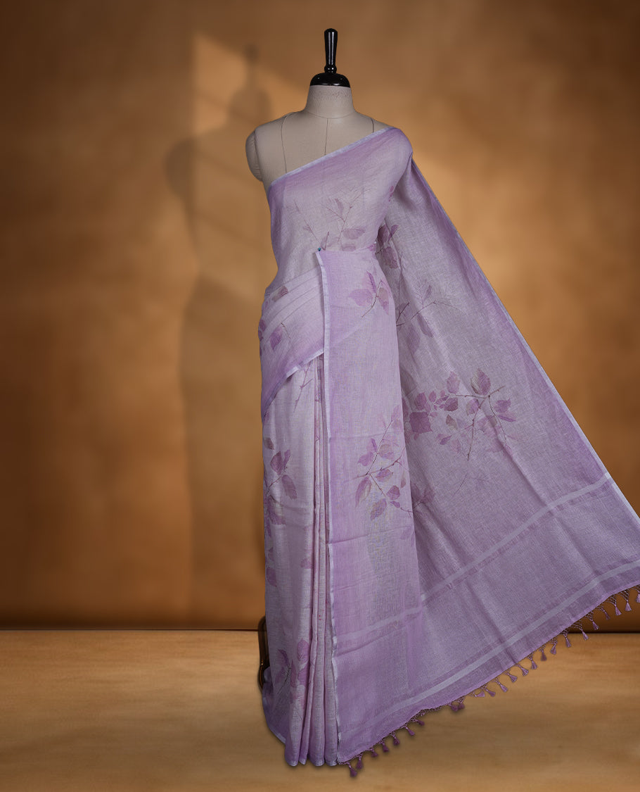 Lavender colour pure linen saree featuring leaf print pattern across body, silver thin border finished with matching blouse.