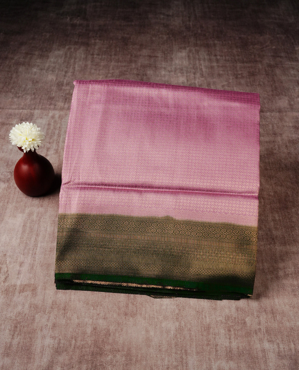 Onion pink colour softie silk saree featuring gold zari, rich pallu floral pattern brocade body, with contrasting forest green colour border.paired with matching blouse piece.