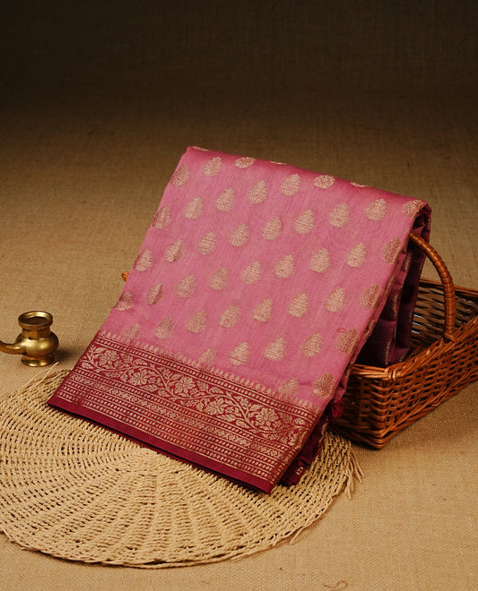 Onion Pink colour Tussar Silk saree featuring antique zari butta motifs on the body, complemented by a contrasting maroon floral zari border and pallu, paired with a matching blouse piece.