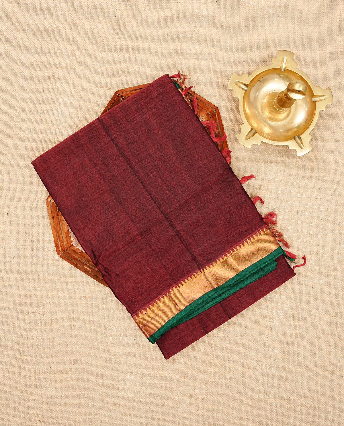 Maroon colour  Narayanapattu cotton saree with a plain body, complemented by a Green colour with Gold Zari temple designed border & contrast pallu, paired with a matching blouse piece