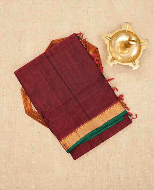 Maroon colour  Narayanapattu cotton saree with a plain body, complemented by a Green colour with Gold Zari temple designed border & contrast pallu, paired with a matching blouse piece