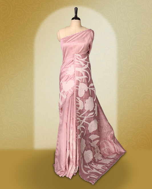 pink colour semi tussar saree featuring elegant white floral and leaf applique work along the body and border, paired with a matching blouse.