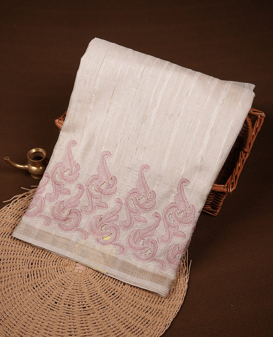 Beige colour Tussar silk saree featuring Elegant plain body, highlighting Purple colour cut work with gold zari border, pallu and paired with matching blouse piece.