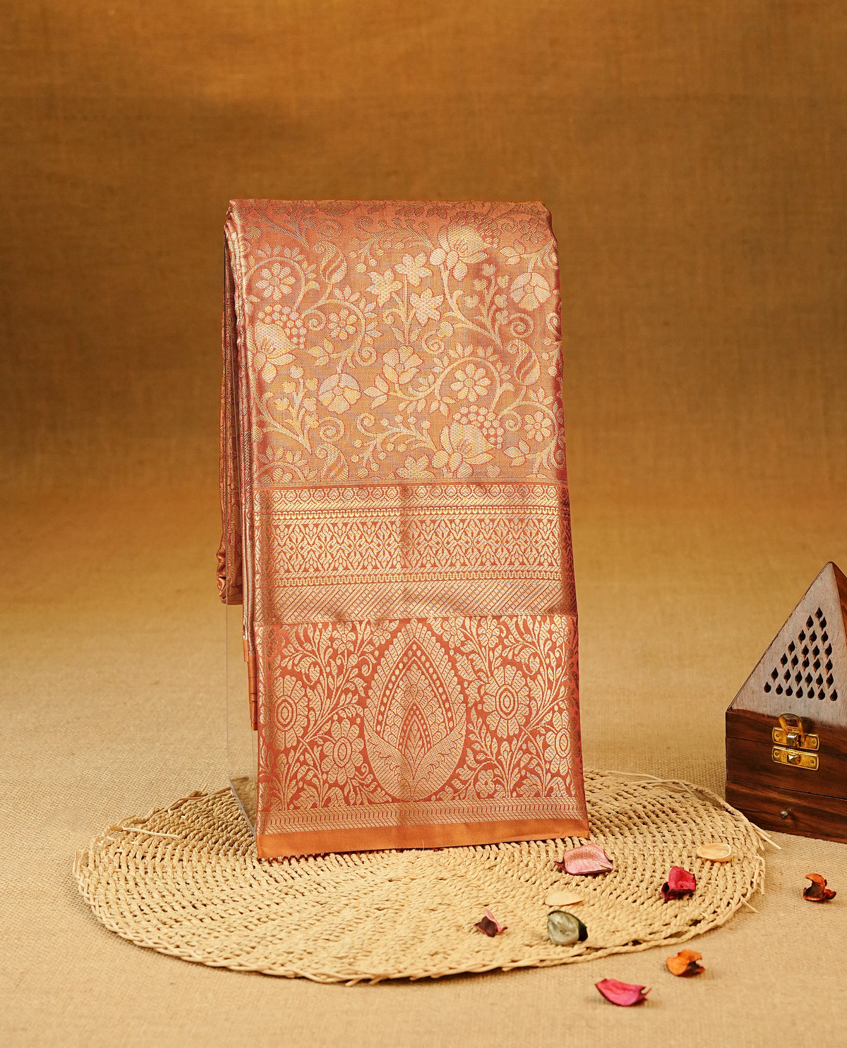 Orange colour Semi Tissue Silk Saree featuring gold zari floral kodi motifs on the body, complemented by an intricately woven gold zari pallu, a rich self-coloured border with gold zari, and paired with a matching plain blouse piece.