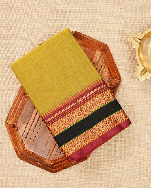 Olive Yellow colour Narayanapattu cotton saree with a plain body, complemented by a maroon colour with gold zari border & contrast pallu, paired with a matching blouse piece.