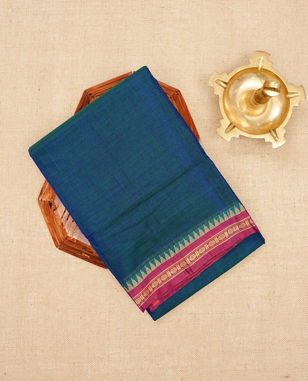 Teal Blue colour Narayanapattu cotton saree with a plain body, complemented by a magenta colour with Gold Zari ,beige colour temple designed border & contrast pallu, paired with a matching blouse piece.