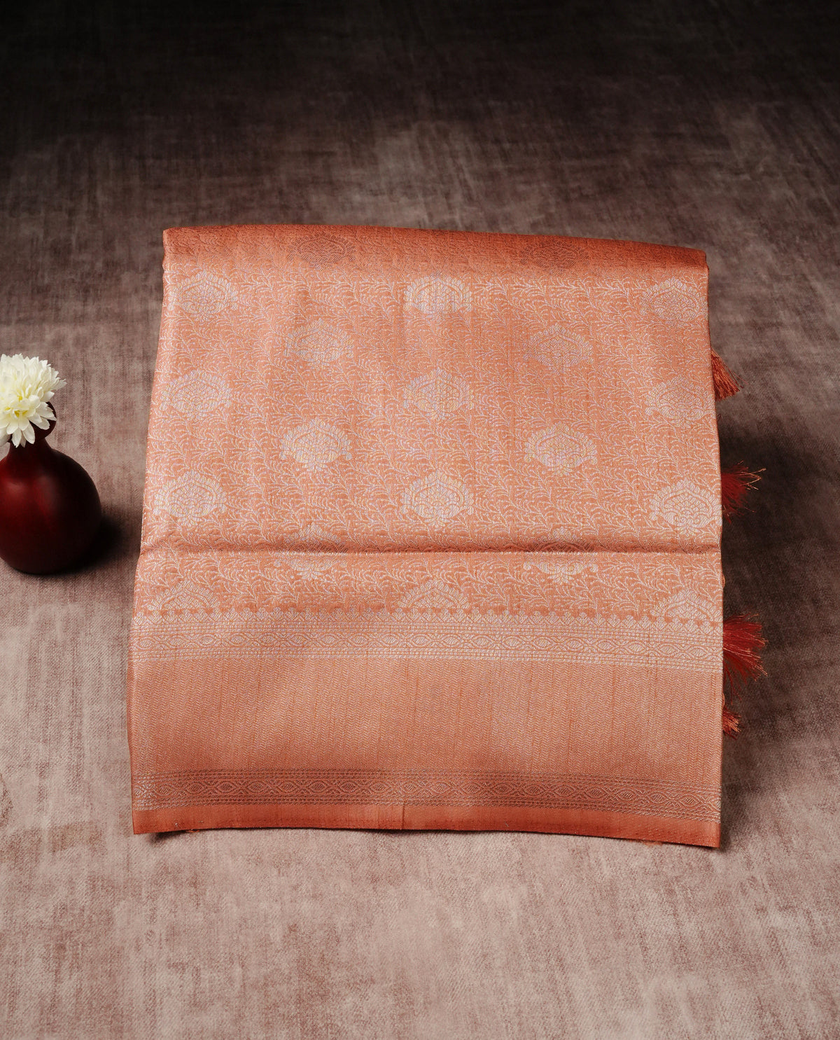 Peach colour softie silk saree featuring silver zari, rich pallu floral pattern brocade body, with contrasting self colour border.paired with matching blouse piece.
