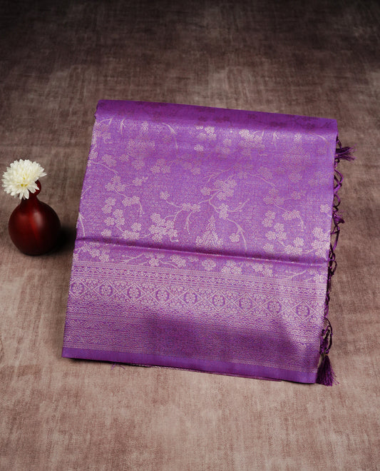 Purple colour softie silk saree featuring silver zari, rich pallu floral pattern brocade body, with contrasting self colour border.paired with matching blouse piece.