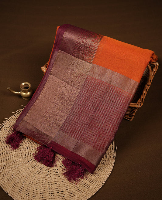 Burnt orange colour semi linen silk saree featuring antique zari motifs on body, traditional border with contrast maroon colour, pallu and paired with matching blouse