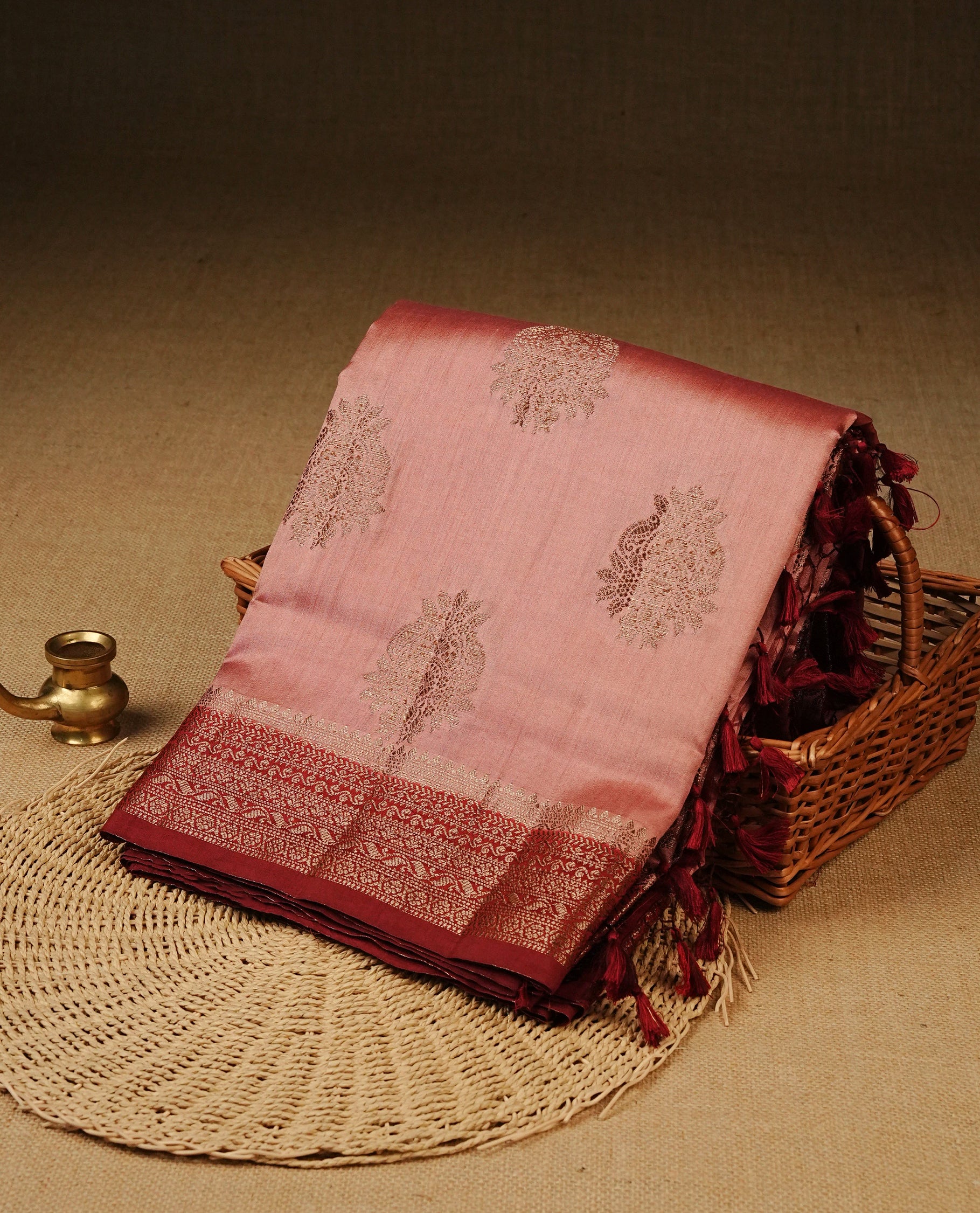 Blush pink  Colour Tussar Silk saree with elegant antique zari floral motifs On Body, a contrasting Maroon zari border, a rich zari pallu, Paired With a matching  blouse piece.