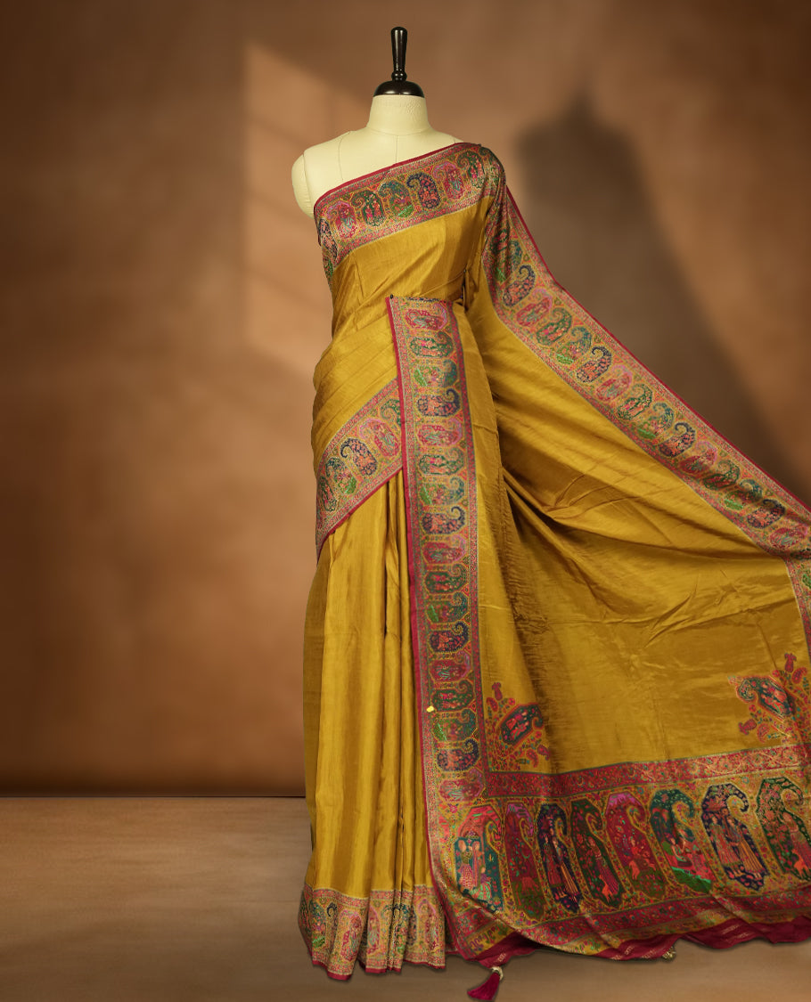 Mustard Pashmina Silk Saree with Plain Body, Featuring Exquisite Multicolor Elephant, Peacock, and Floral Motifs on Rich Pink-Green Zari Border & Grand Pallu, Paired with Matching Blouse Piece