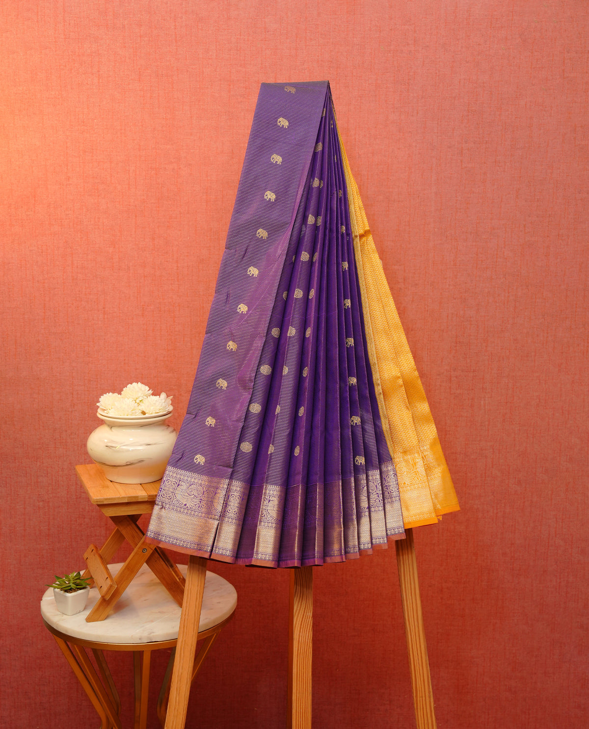 Purple colour soft silk saree featuring gold zari lines with elephant motifs on body, Self colour gold zari peacock and traditional on border, grand pallu comes with matching blouse piece.