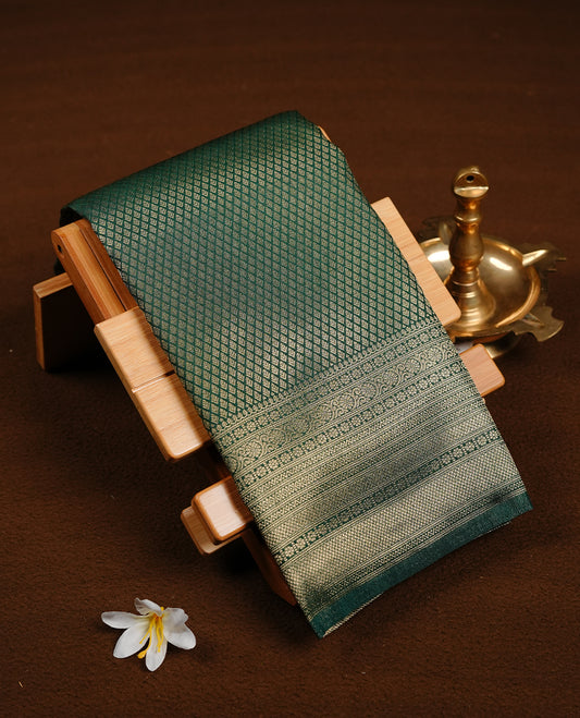 Emerald green colour soft silk saree featuring gold zari pattern on body, complemented by self colour with traditional border, paired with matching blouse piece.