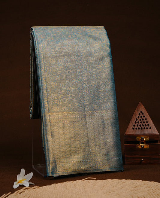 Blue & Gold colour semi tissue silk saree featuring gold zari floral kodi pattern on body, self colour with gold zari traditional border, paired with matching blouse piece.